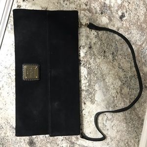 Woman’s black suede clutch